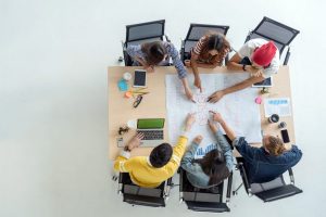 Top view scene of Asian and Multiethnic Business people with casual suit working with brainstorming and pointing to the design concept in the modern workplace, people business group concept