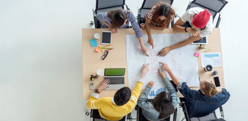 Top view scene of Asian and Multiethnic Business people with casual suit working with brainstorming and pointing to the design concept in the modern workplace, people business group concept
